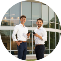 Two students smile in front of Bowers Hall